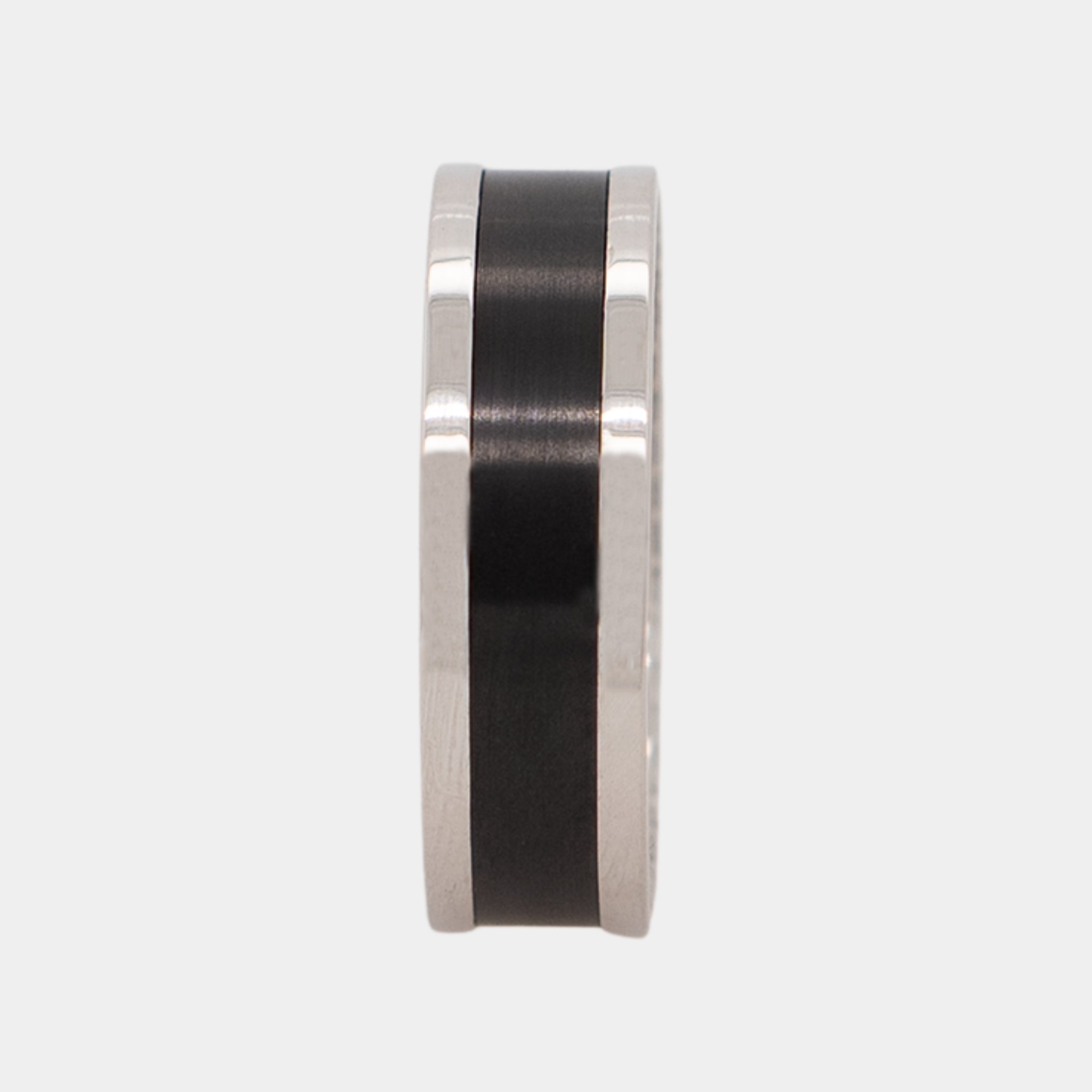 ZEUS ring – 7mm black diamond men’s ring with a platinum band, black diamond inlay, and white diamond insets. Ring standing upright to show the 7mm band profile and clean platinum edges.